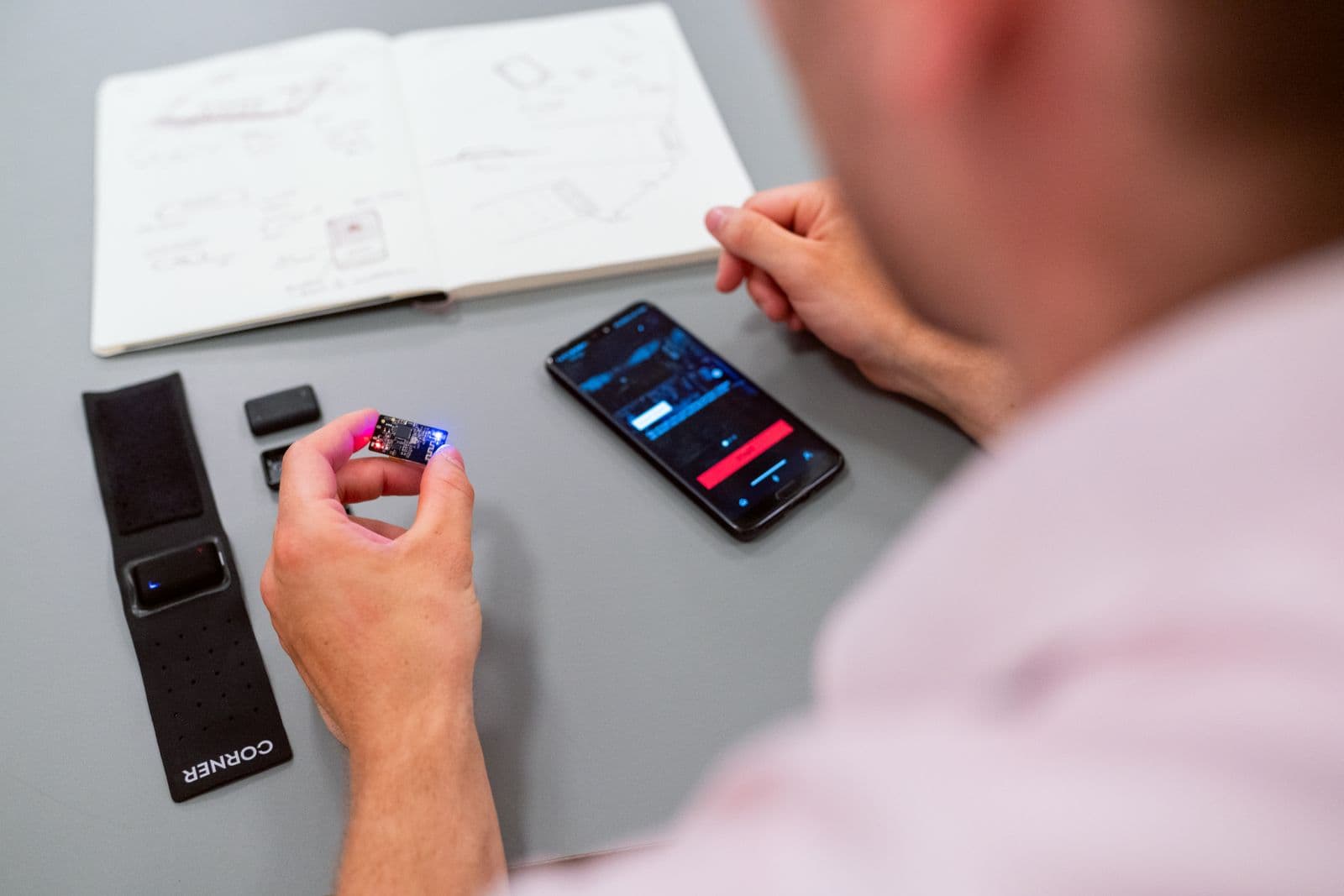 Engineer testing a mobile application at a desk